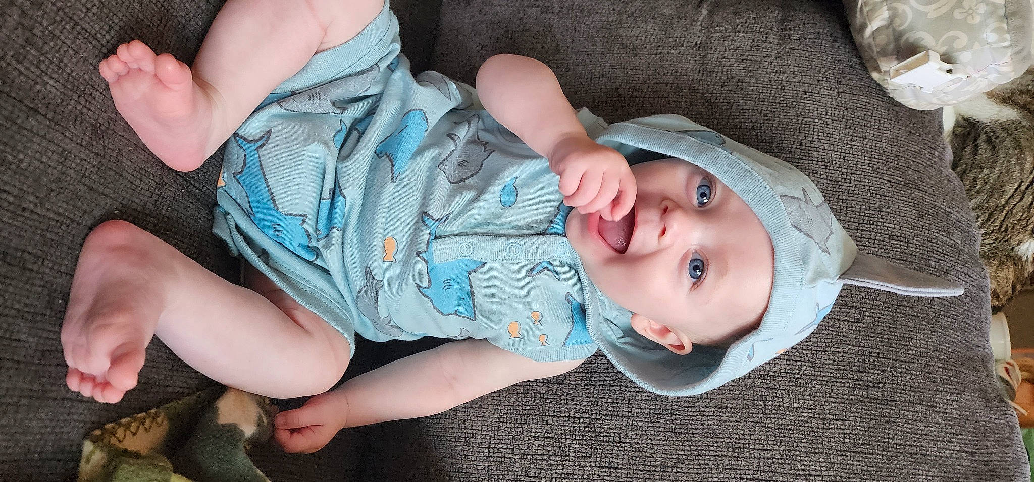 Patrick is registered to the contest to win money with this photo: baby, baby_products, baby_toddler_clothing, cheek, child, comfort, eye, eyelash, finger, grass, hand, hat, headwear, human_body, mouth, nose, person, product, sitting, skin