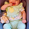 baby, infant, child, smiling, happy, portrait, car_seat, headband, flower, clothing, pastel, toy, stuffed_animal, finger, sitting, indoor, close_up, face, safe, photography