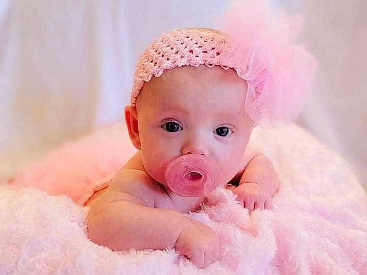 Emily is registered to the contest to win money with this photo: baby, baby_sleeping, baby_toddler_clothing, cap, child, eye, fashion_accessory, fur, hair_accessory, happy, head, headband, headgear, headpiece, linens, lip, person, pink, smile, surprise