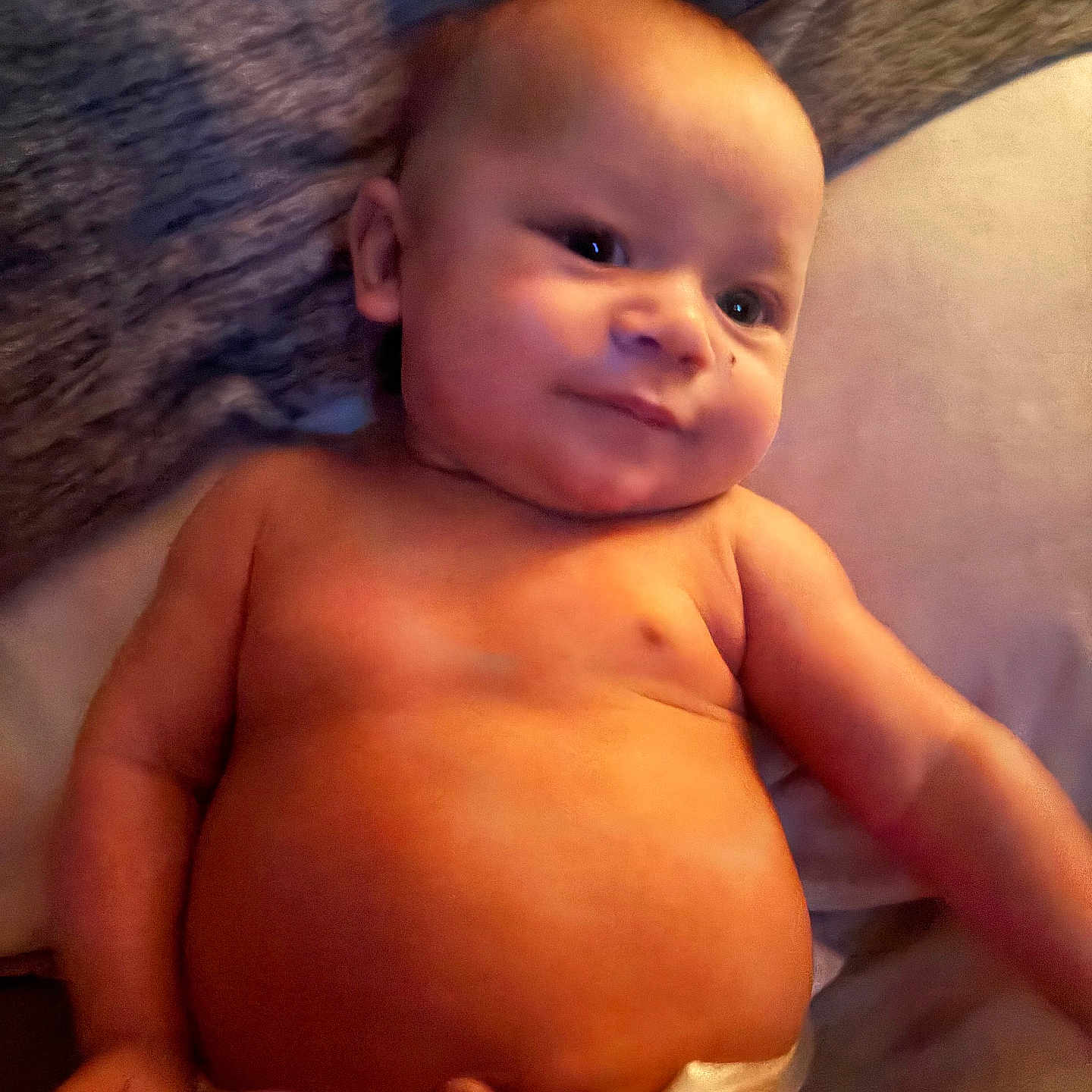 Kenlee is registered to the contest to win money with this photo: arm, baby, child, chubby, cute, diaper, expression, face, happy, head, indoors, infant, lying_down, newborn, person, resting, skin, smile, soft_lighting, torso