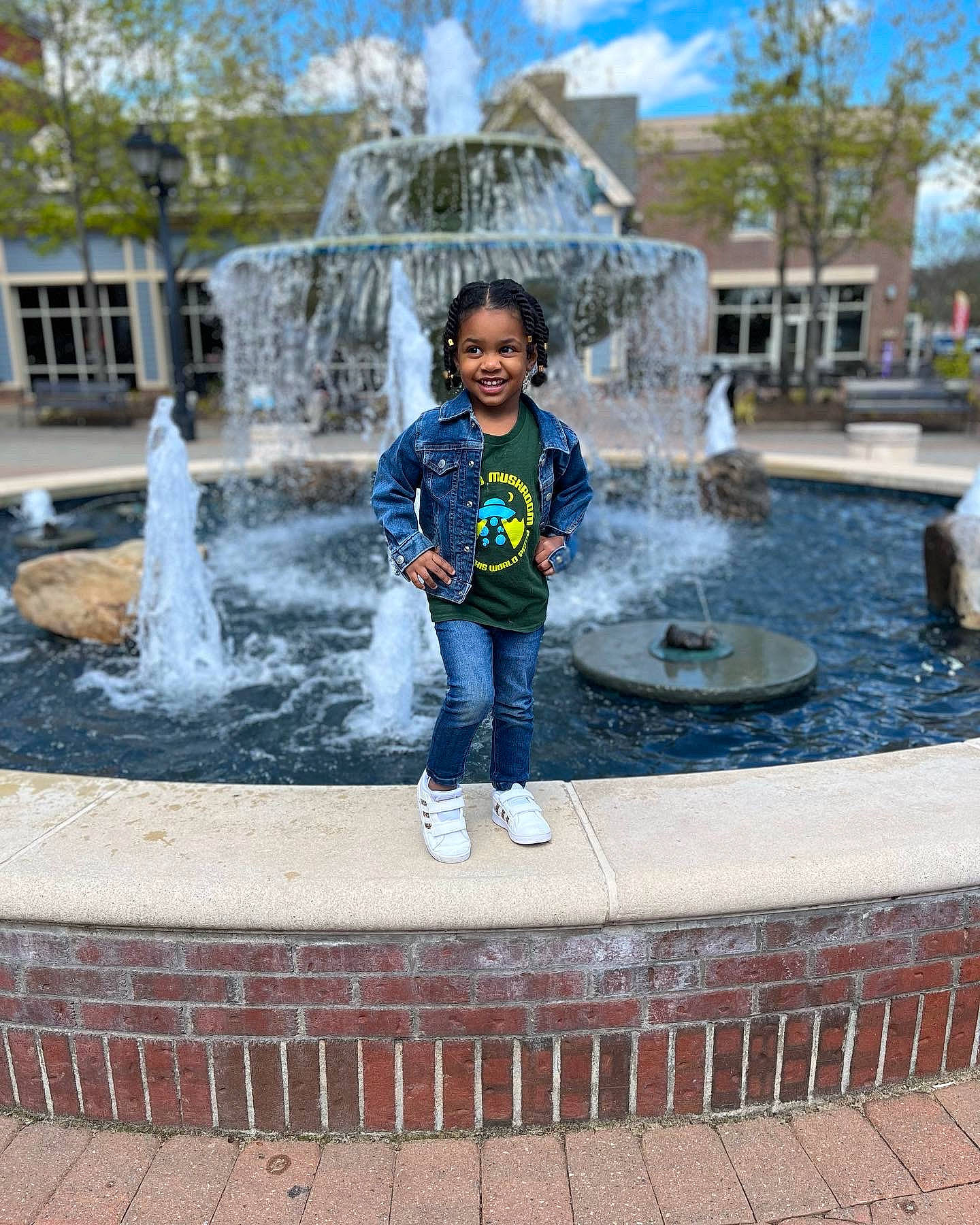 Kimberlee is registered to the contest to win money with this photo: cloud, composite_material, font, fountain, fun, human_settlement, joy, landmark, leisure, line, people, person, photograph, recreation, sky, smile, snapshot, toddler, tree, water