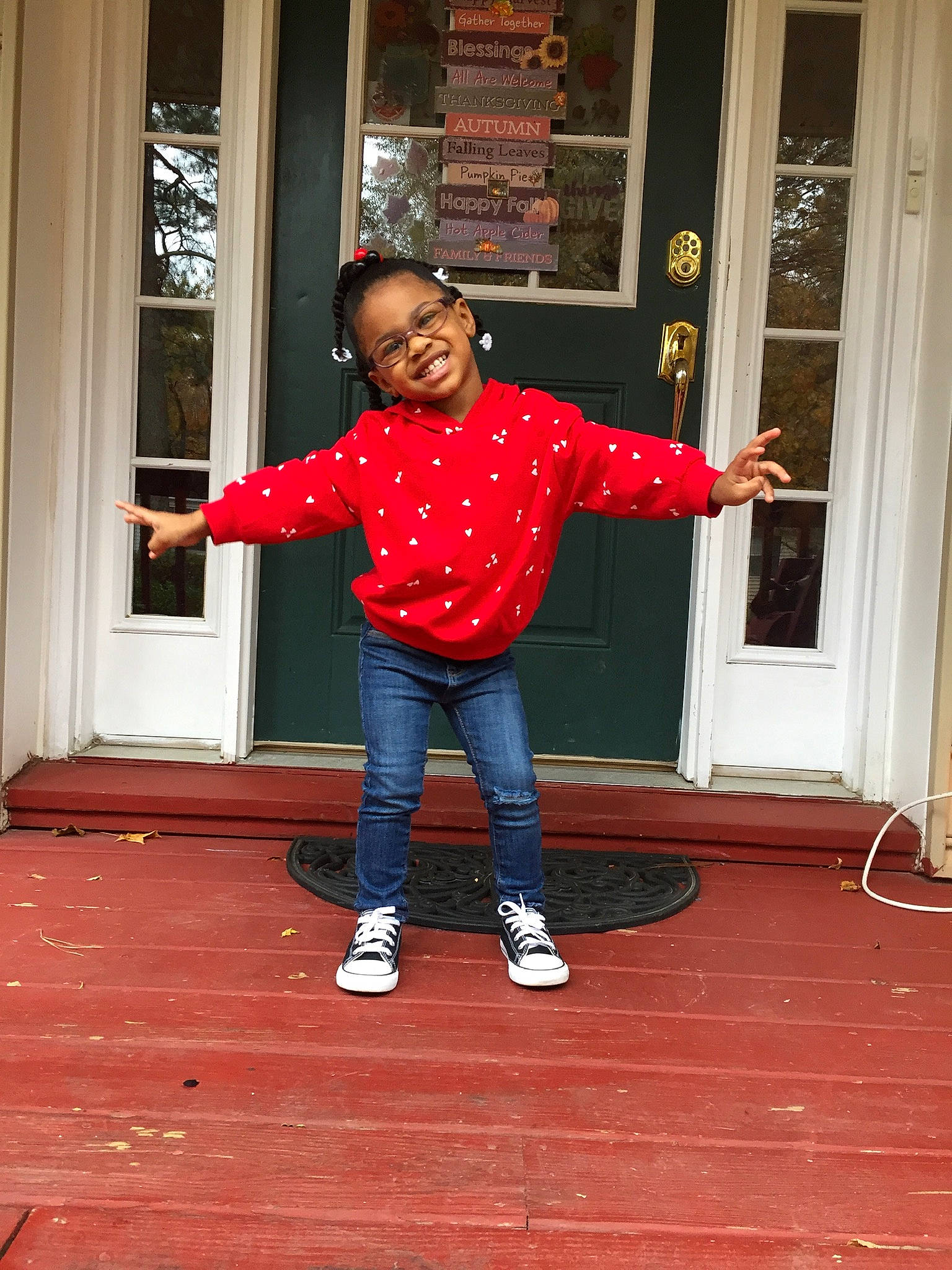 Kimberlee is registered to the contest to win money with this photo: denim, door, eye, floor, flooring, fun, gesture, happy, head, joy, leg, person, red, shoe, sleeve, smile, sneakers, standing, t_shirt, toddler