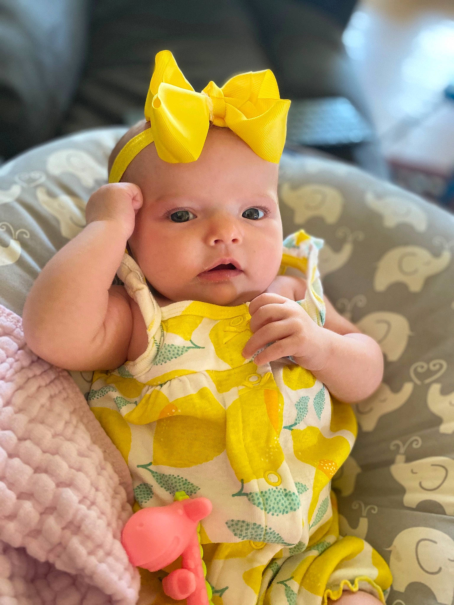 Harper is registered to the contest to win money with this photo: baby, baby_products, baby_toddler_clothing, cheek, child, comfort, eye, face, finger, fun, happy, head, headwear, iris, pattern, person, pink, product, skin, textile