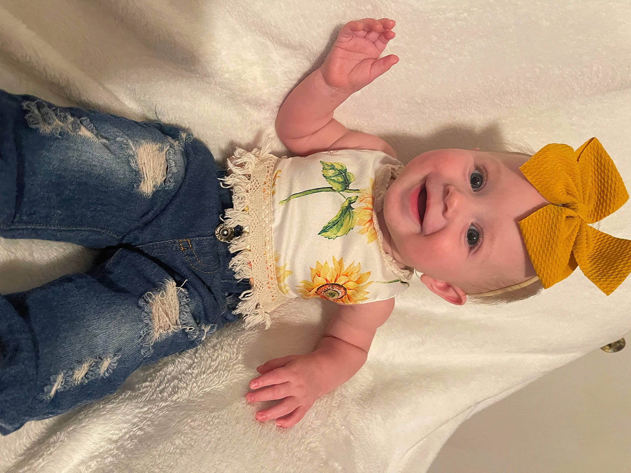 Fallon is registered to the contest to win money with this photo: abdomen, arm, baby, baby_sleeping, baby_toddler_clothing, child, comfort, eye, facial_expression, fashion_accessory, finger, gesture, hair_accessory, happy, headgear, headwear, joy, linens, person, skin