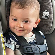 Zev is registered to the contest to win money with this photo: accessories, baby, belt, blonde, clothing, cushion, face, happy, head, homedecor, lifejacket, person, photography, portrait, smile, strap, t_shirt, transportation, vehicle, vest