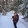 Cheddar is registered to the contest to win money with this photo: woman, cat, snow, forest, trees, winter, outdoor, path, boots, jacket, smile, animal, nature, pet, cold, daylight, happy, fur, walking, scenery