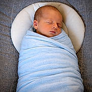 Lucien participe au concours pour gagner de l'argent avec cette photo : baby, newborn, infant, swaddle, blanket, sleeping, sleep, wrap, face, head, pillow, cushion, bedding, fabric, blue, grey, portrait, cute, resting, peaceful