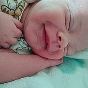 Emmett is registered to the contest to win money with this photo: baby, sleeping, smile, face, hand, blanket, soft, cozy, infant, cute, rest, peaceful, closeup, skin, newborn, comfort, nap, portrait, child, toddler