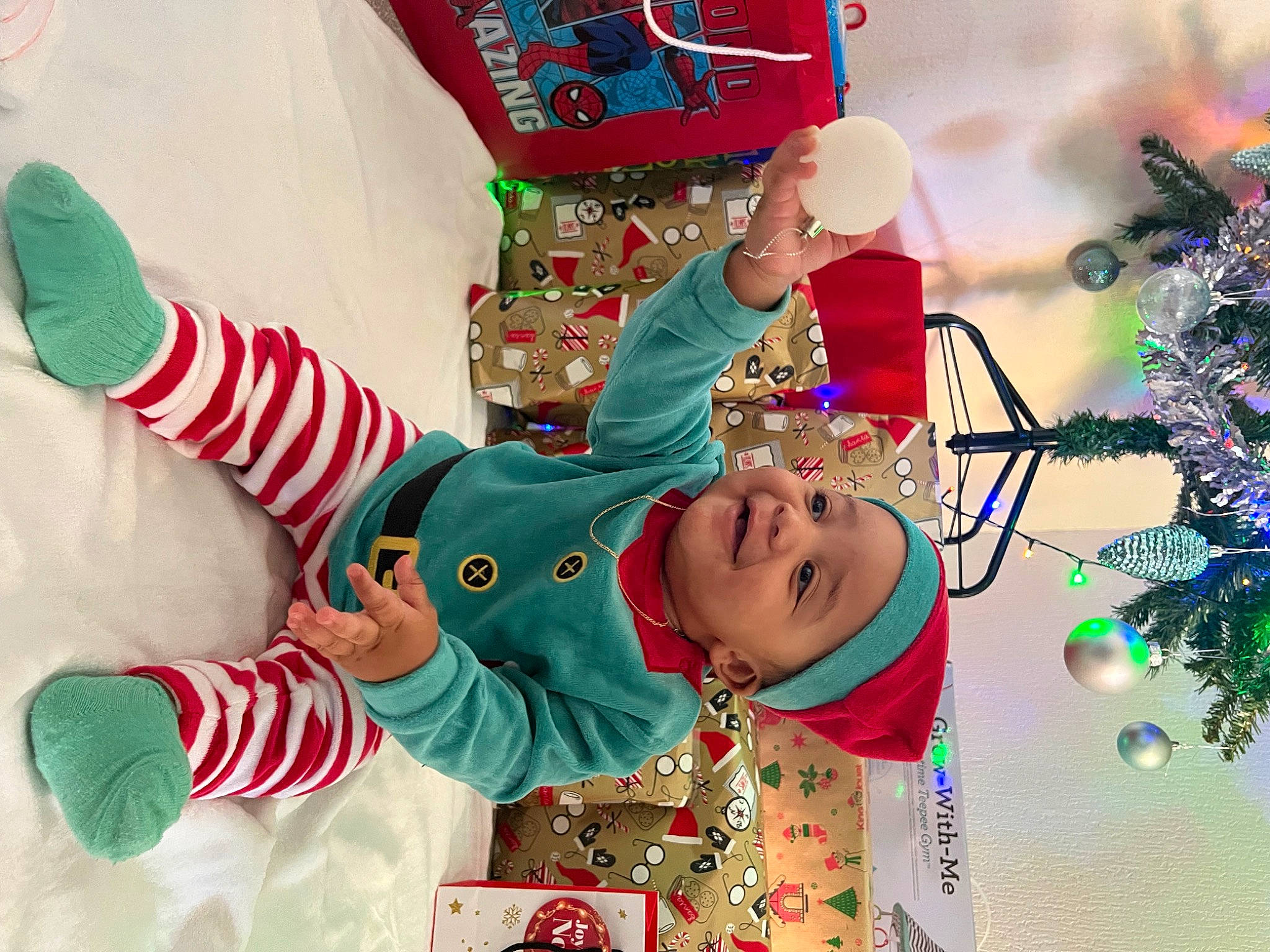 Jahriel participe au concours pour gagner de l'argent avec cette photo : baby, baby_toddler_clothing, child, christmas, christmas_decoration, christmas_ornament, christmas_stocking, christmas_tree, event, facial_expression, fictional_character, green, happy, headwear, holiday, holiday_ornament, joy, person, sleeve, smile