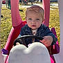 Emma joined the competition — help win amazing prizes! child, toddler, toy_car, outdoor, playground, steering_wheel, pink, denim_jacket, headband, blue_eyes, sunlight, grass, play, cute, young_child, person, daylight, casual_clothing, vehicle, fun