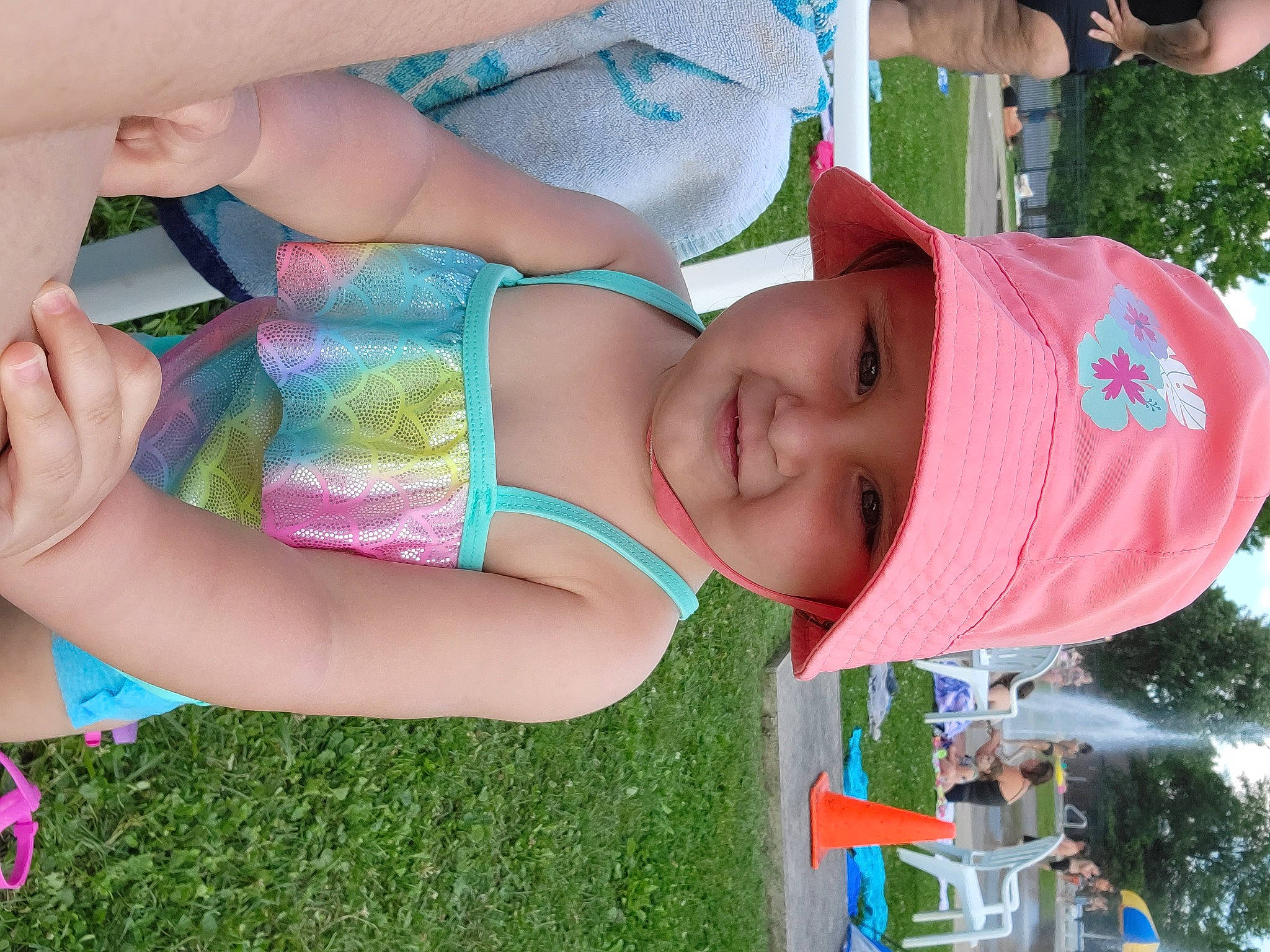Amelia Rose is registered to the contest to win money with this photo: arm, blue, child, community, finger, fun, grass, green, hand, happy, hat, headwear, joy, leisure, people_in_nature, person, pink, plant, public_space, recreation