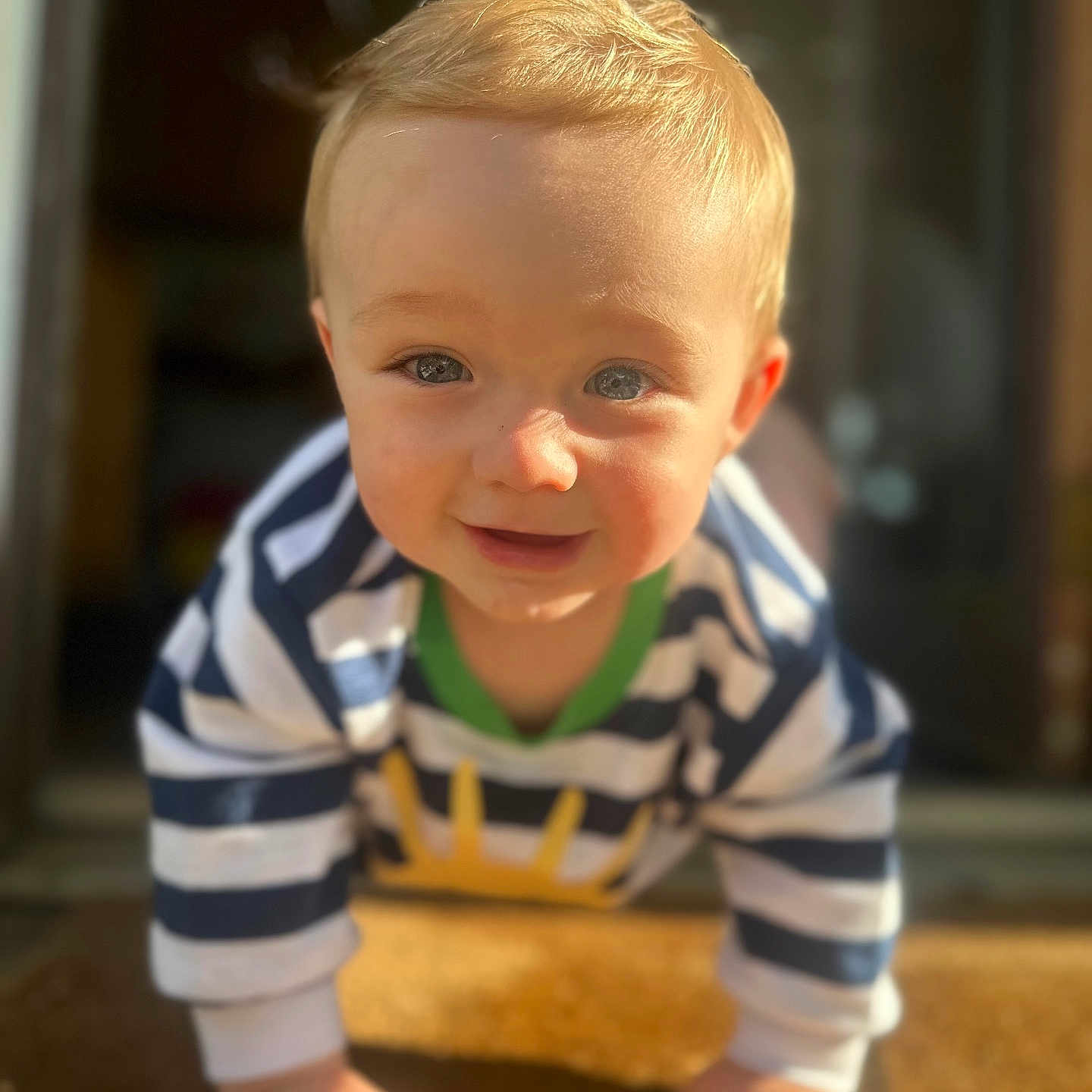 Lucky joined the competition — help win amazing prizes! baby, blonde_hair, blue_eyes, casual_clothing, child, closeup, crawling, cute, doormat, face, hands, happy, indoor, infant, person, portrait, smiling, striped_clothing, sunlight, young_child
