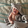 baby, blanket, child, comfort, cute, expression, face, happy, hood, indoors, infant, joyful, lying_down, portrait, skin, smiling, soft, striped, towel, wrapped