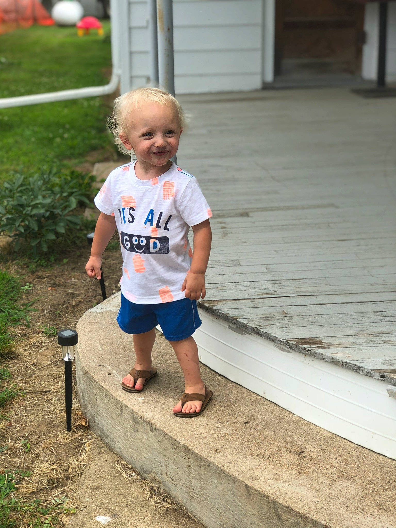 Kalel is registered to the contest to win money with this photo: child, fun, grass, joy, male, people, person, play, recreation, smile, standing, summer, t_shirt, toddler, vacation, water