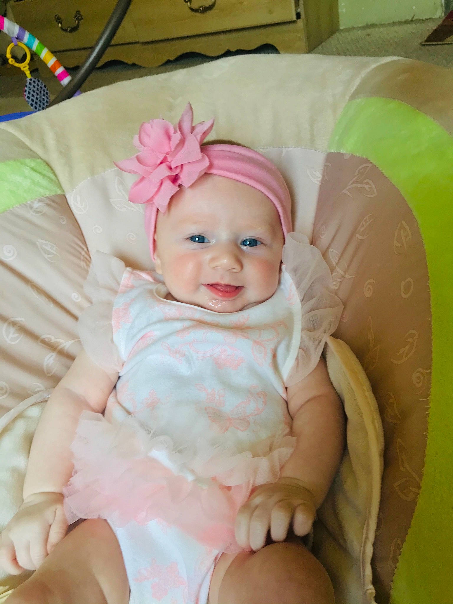 Lilly is registered to the contest to win money with this photo: baby, baby_toddler_clothing, cheek, comfort, dress, eye, eyebrow, face, finger, happy, head, headgear, headwear, iris, person, pink, product, purple, skin, smile