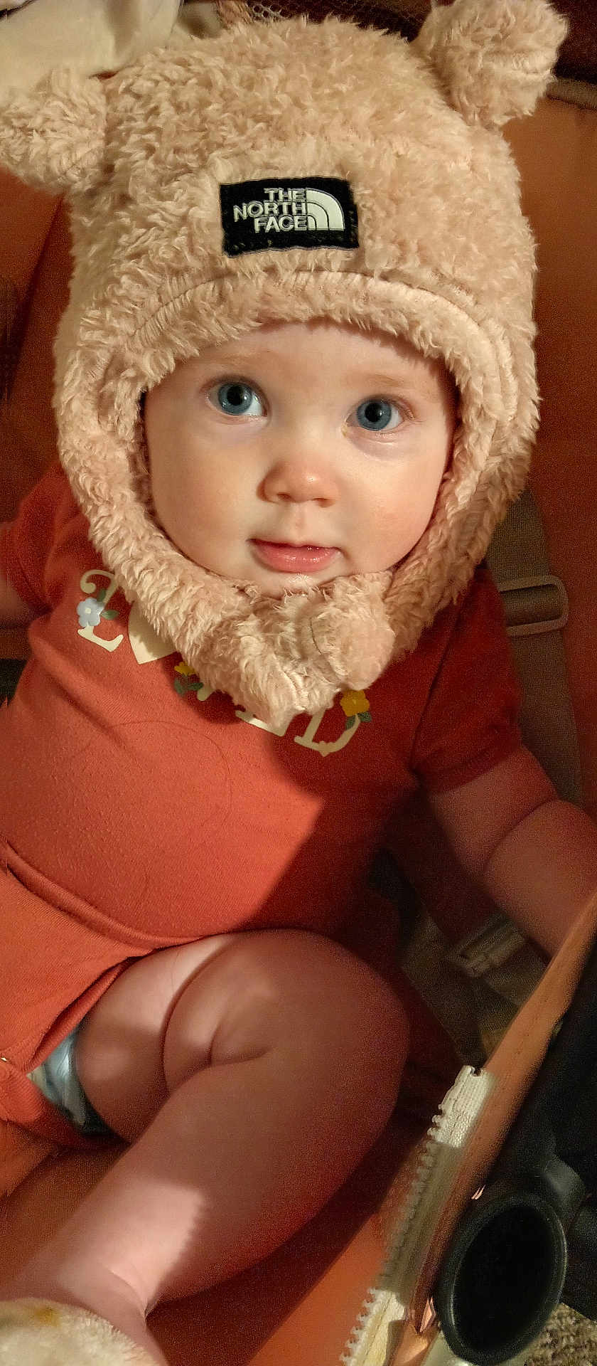 Ellianah is registered to the contest to win money with this photo: baby, child, face, hat, fluffy, blue_eyes, cute, infant, clothing, orange_outfit, sitting, portrait, indoor, warm, soft_texture, headwear, young_child, closeup, person, adorable