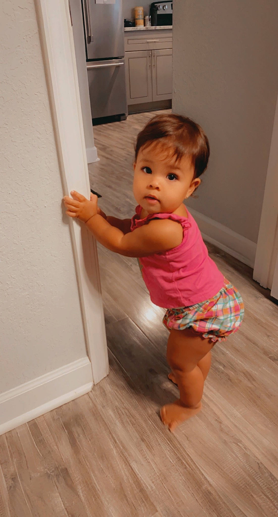 Avery is registered to the contest to win money with this photo: baby_toddler_clothing, barefoot, chest, child, finger, flooring, fun, hardwood, human_leg, joint, knee, laminate_flooring, person, standing, stomach, thigh, toddler, trunk, waist, wood