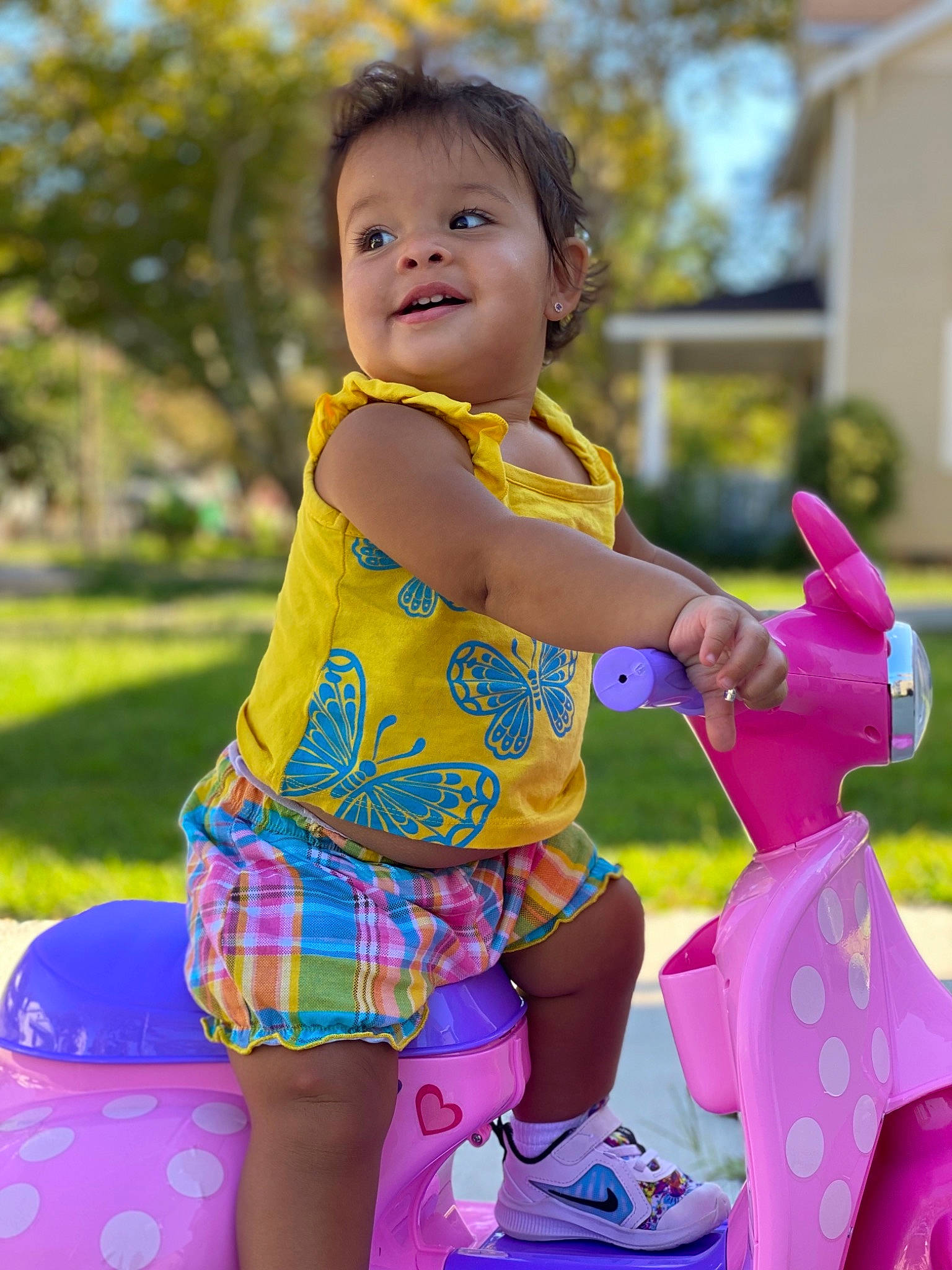 Emery is registered to the contest to win money with this photo: baby_toddler_clothing, child, city, fun, grass, happy, leisure, magenta, pattern, people_in_nature, person, pink, play, playground, public_space, recreation, sitting, smile, summer, toddler