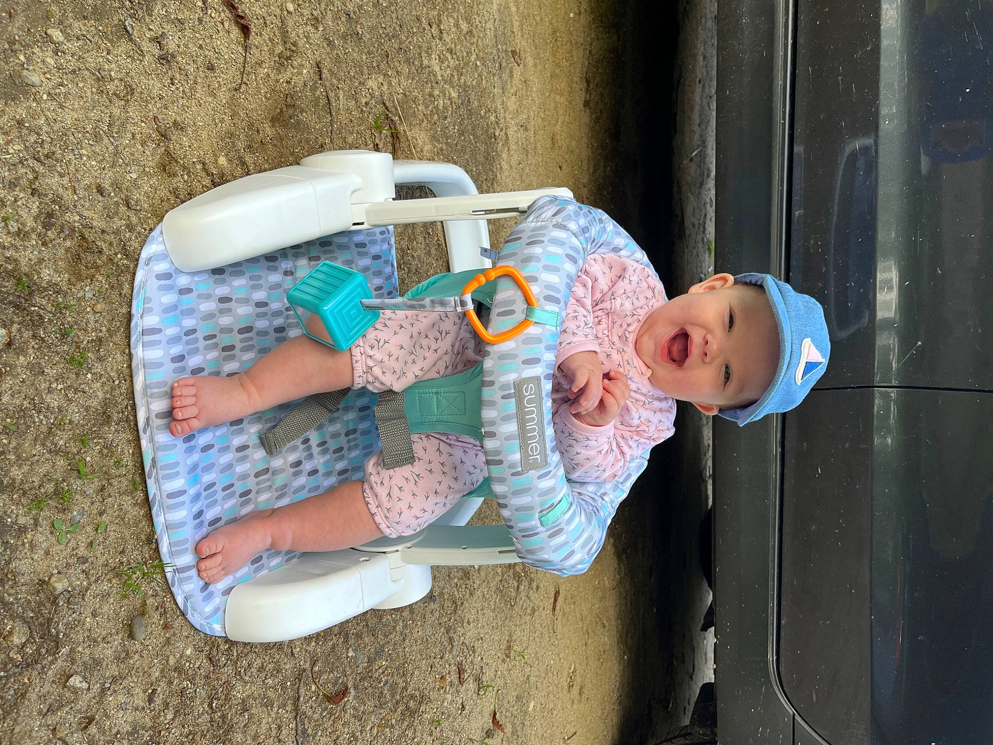 Gracelynn is registered to the contest to win money with this photo: baby, baby_products, baby_toddler_clothing, cap, child, electric_blue, fun, hat, headwear, helmet, leisure, person, play, sitting, toddler, tree, water, wood