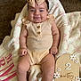 Macie is registered to the contest to win money with this photo: baby, infant, smiling, bow, headband, blanket, clothing, socks, milestone, sign, wooden_sign, flower, cute, portrait, happy, indoor, soft_texture, human, child, candid