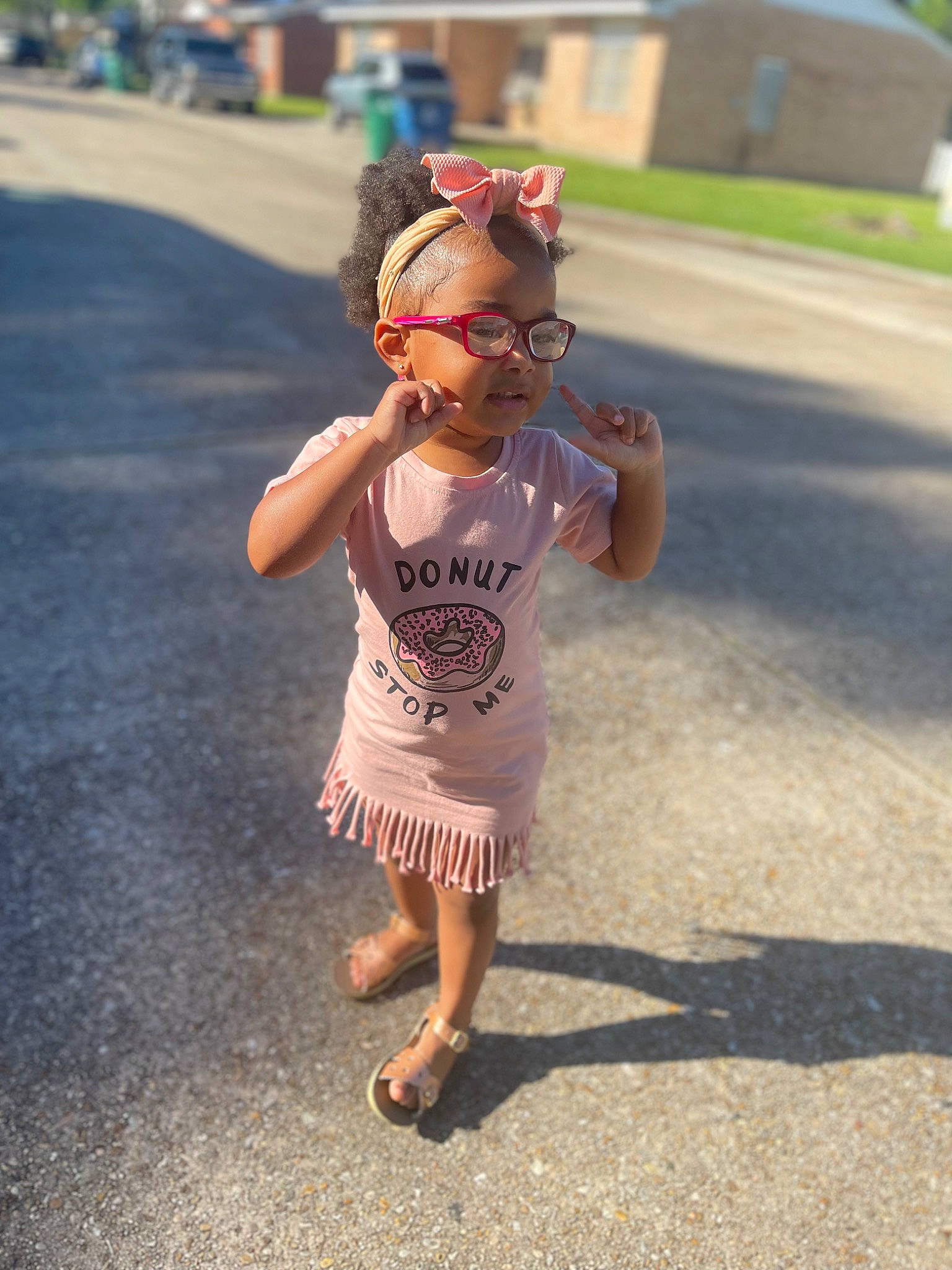 Korbyn is registered to the contest to win money with this photo: asphalt, barefoot, child, eyewear, foot, fun, grass, happy, human_leg, leisure, person, personal_protective_equipment, recreation, road, road_surface, sandal, street, thigh, toddler, waist