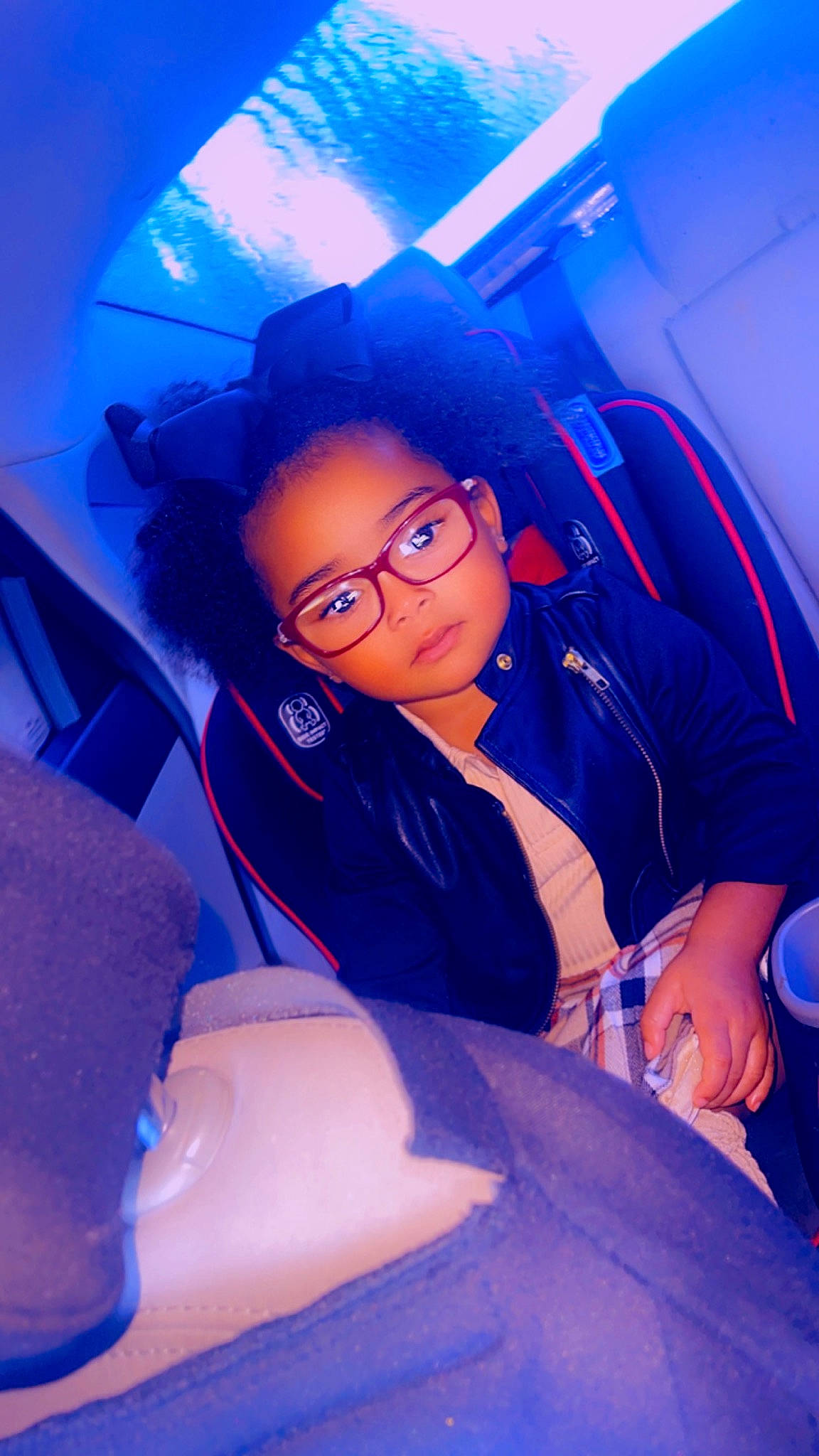 Korbyn is registered to the contest to win money with this photo: automotive_design, azure, blue, car, car_seat, car_seat_cover, comfort, eyewear, flash_photography, fun, glasses, head_restraint, leisure, motor_vehicle, person, purple, smile, toddler, vehicle, vehicle_door