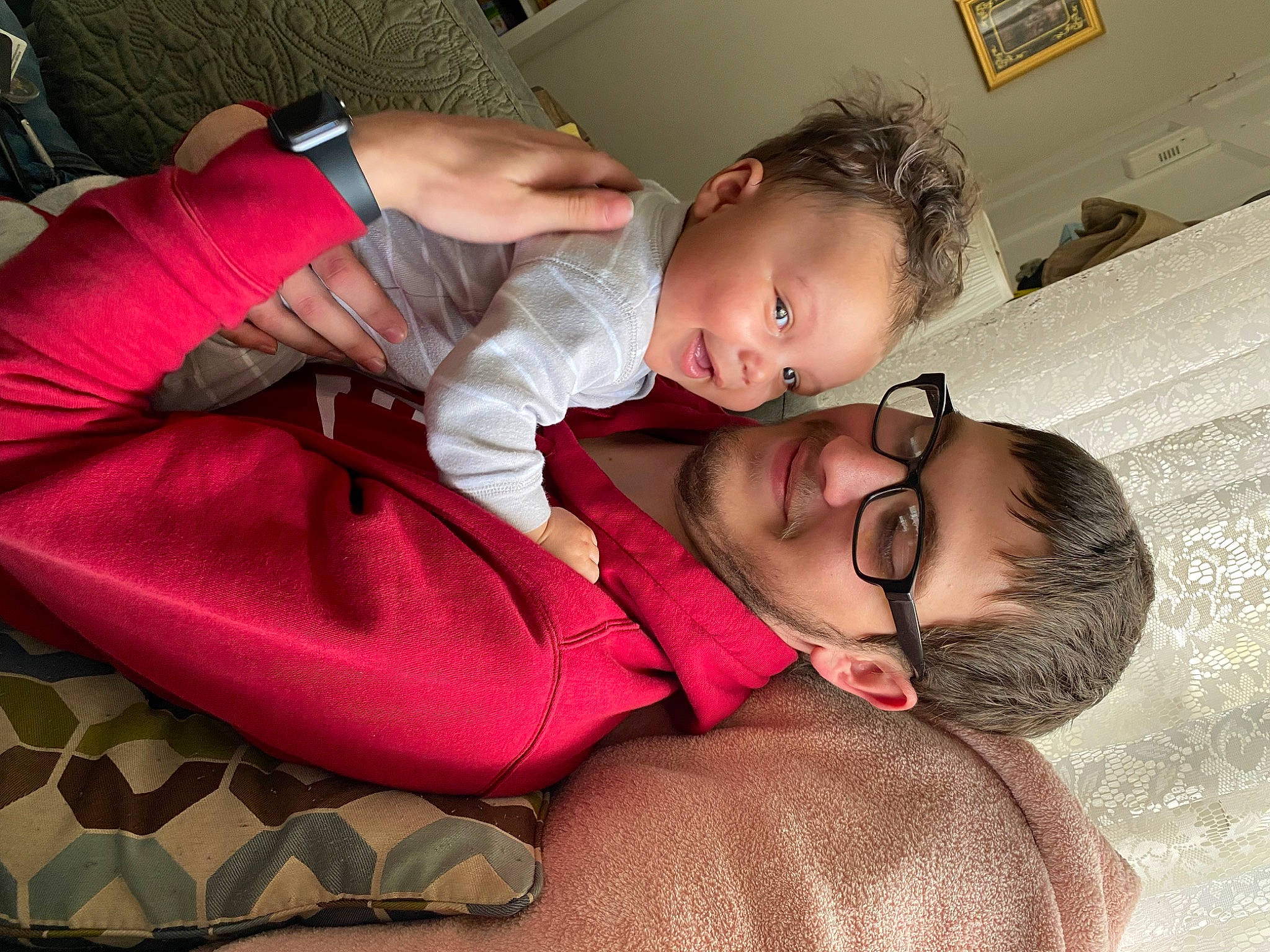 Ryder is registered to the contest to win money with this photo: baby, baby_toddler_clothing, cheek, child, comfort, event, facial_expression, fun, happy, head, human_body, interaction, joy, lap, mouth, nose, person, pink, shoulder, skin