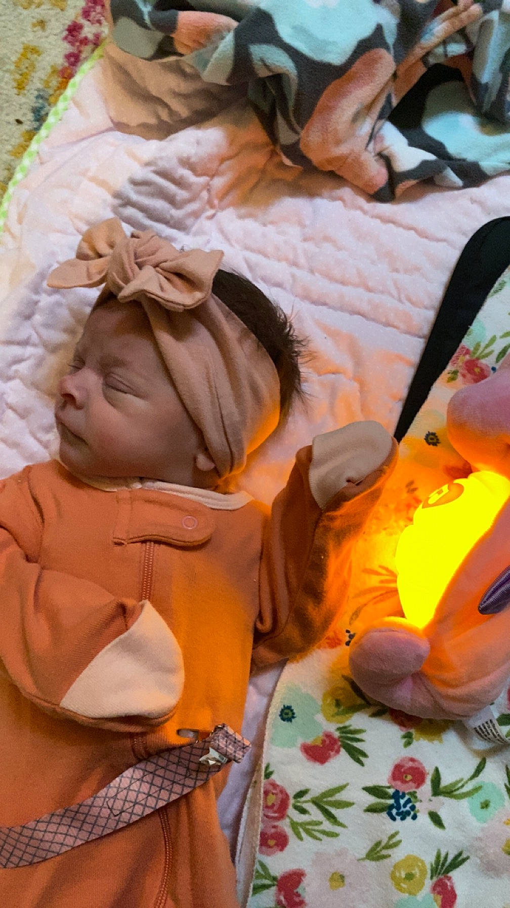 Aria is registered to the contest to win money with this photo: abdomen, art, baby, child, event, fun, fur, grass, happy, headwear, leisure, mouth, orange, peach, person, plant, sitting, stuffed_toy, toddler, tradition