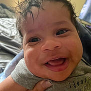 Dandre is registered to the contest to win money with this photo: baby, smiling, closeup, indoor, child, happy, face, hand, hair, tshirt, person, infant, cute, expression, young, skin, portrait, clothing, human, joy
