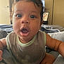 Dandre joined the competition — help win amazing prizes! baby, child, face, expression, surprised, bib, clothing, indoor, bed, blanket, lamp, person, skin, hair, mouth, eyes, arm, infant, cute, portrait