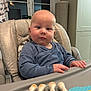 Daniel is registered to the contest to win money with this photo: baby, child, high_chair, blue_sweater, toy, giraffe_toy, teething_ring, indoor, curious, infant, face, hands, furniture, window, cozy, expression, seat, home, portrait, cute