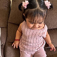 Lindsay Reyes joined the competition — help win amazing prizes! toddler, child, girl, hairclips, pink_clothing, knitwear, shorts, sitting, couch, brown_couch, indoors, bracelet, red_bracelet, happy, cute, portrait, home, smiling, young_child, casual