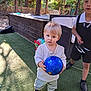 Liam participe au concours pour gagner de l'argent avec cette photo : toddler, child, soccer_ball, outdoor, grass, toy, play, blue_ball, young_child, casual_clothing, daylight, shoes, person, nature, sunlight, trees, fence, wicker_chair, backyard, curious