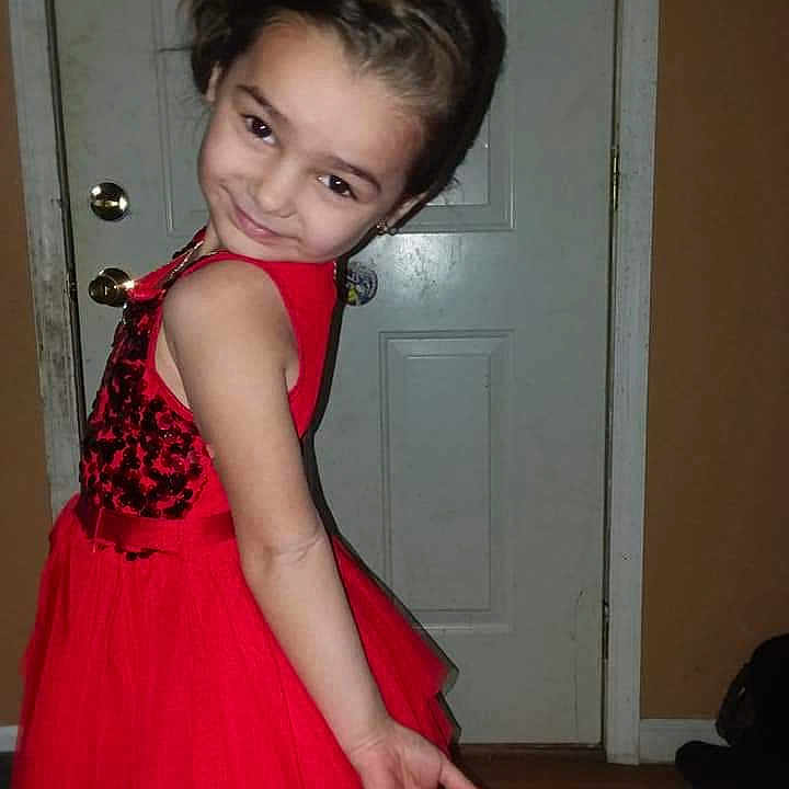 Arora is registered to the contest to win money with this photo: abdomen, brown_hair, child, child_model, cocktail_dress, dress, girl, gown, hair, hairstyle, human_hair_color, joint, lady, leg, long_hair, person, shoulder, skin, smile, standing