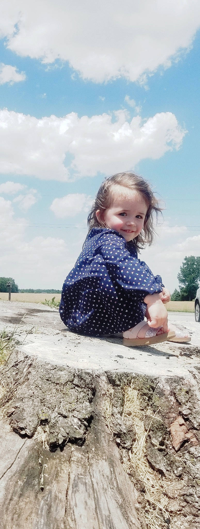 Sidney is registered to the contest to win money with this photo: body_of_water, cloud, denim, electric_blue, flash_photography, grass, hairstyle, happy, joy, landscape, leisure, long_hair, pattern, person, plant, sky, sleeve, smile, toddler, travel
