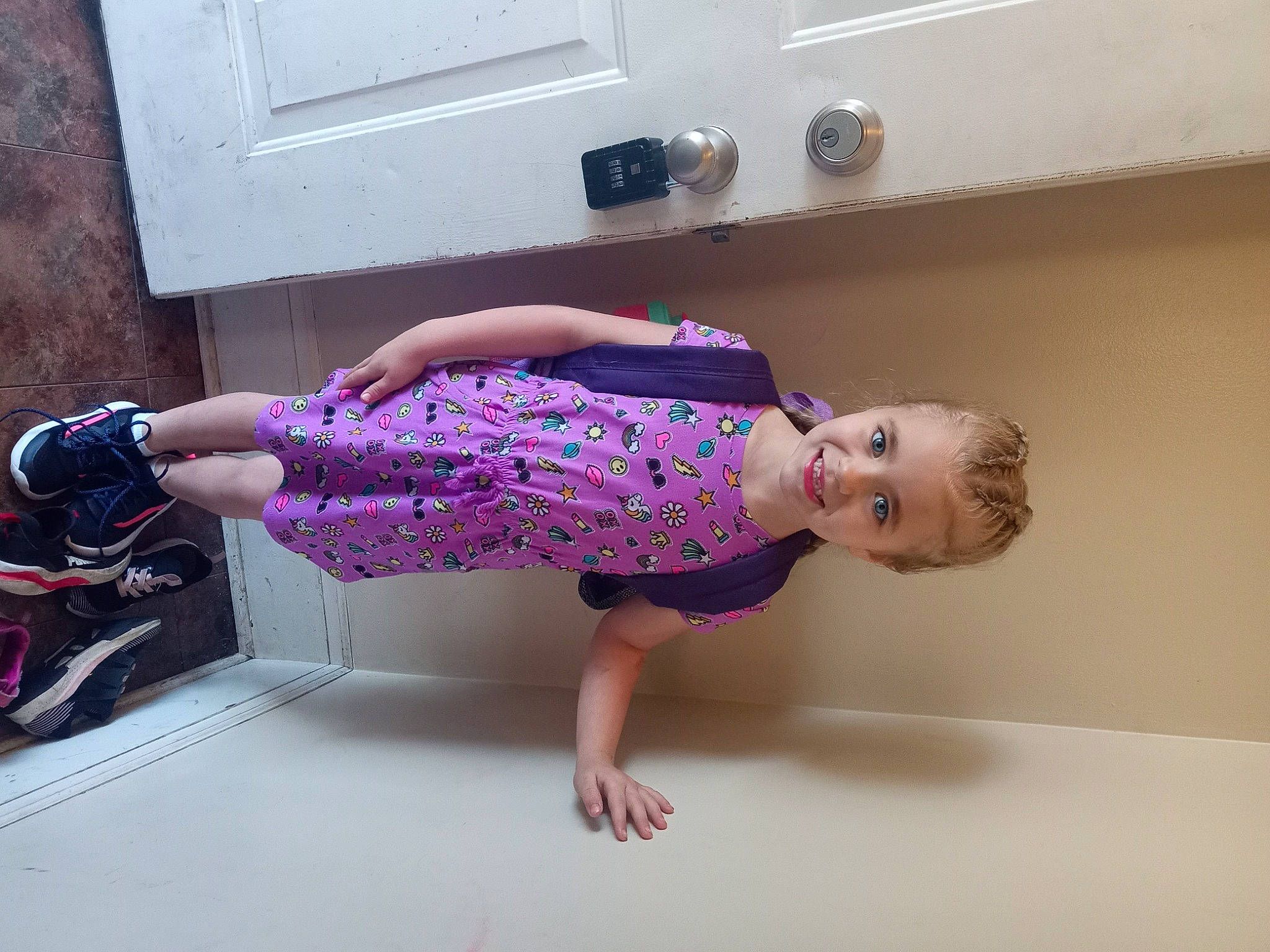A'Mya is registered to the contest to win money with this photo: baby_toddler_clothing, child, dress, elbow, flooring, fun, human_leg, joint, joy, knee, magenta, pattern, person, pink, purple, room, sandal, sleeve, thigh, toddler
