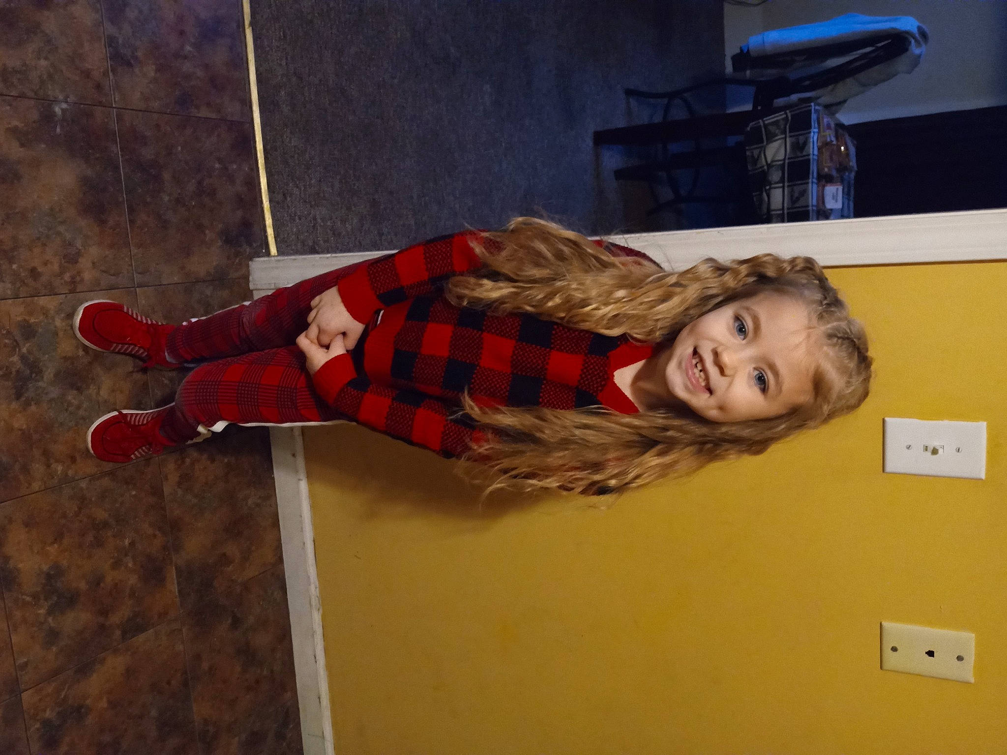 A'Mya is registered to the contest to win money with this photo: child, flooring, fun, joy, pattern, person, plaid, room, smile, tartan, wood