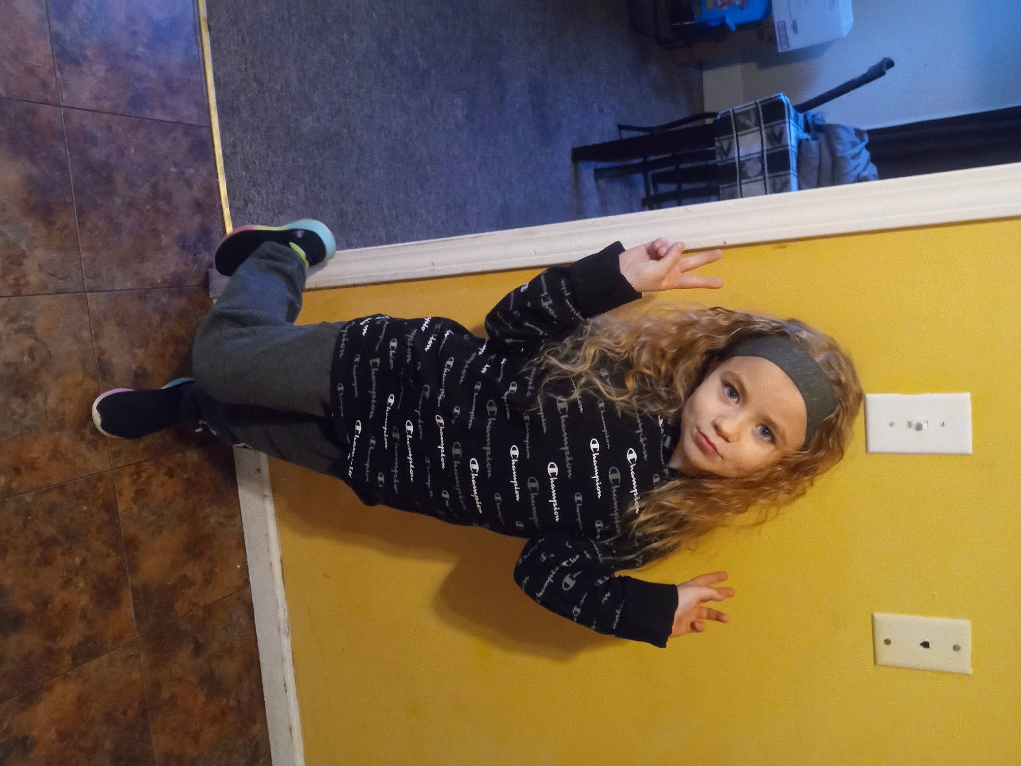 A'Mya is registered to the contest to win money with this photo: elbow, flooring, fun, gesture, headwear, human_leg, knee, person, room, smile, sportswear, thigh, waist, wrist