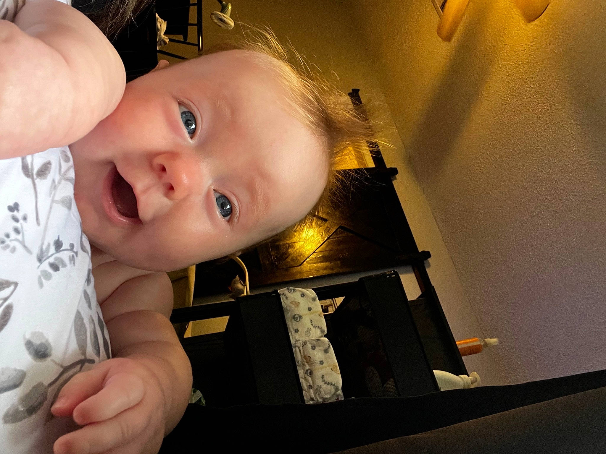 June is registered to the contest to win money with this photo: baby, baby_toddler_clothing, ceiling, cheek, child, chin, eyelash, flash_photography, fun, happy, iris, lighting_accessory, nose, person, portrait_photography, room, sitting, smile, thumb, toddler