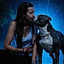Reich participe au concours pour gagner de l'argent avec cette photo : woman, dog, rain, wet_hair, tattoo, blue_lighting, night, outdoor, leash, closeup, affection, pet, animal, portrait, love, water_drops, dark_background, casual_clothing, bond, emotion