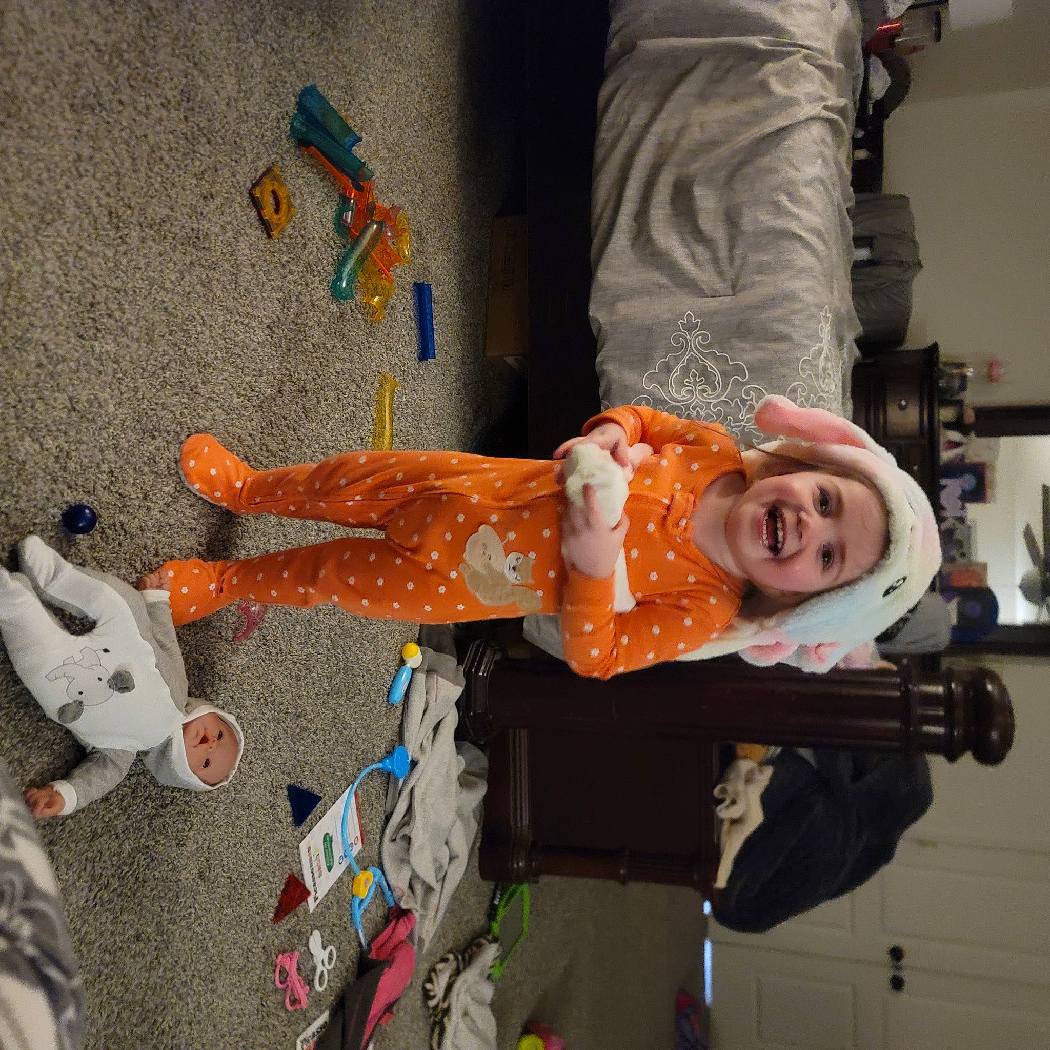 Remie is registered to the contest to win money with this photo: art, child, costume, fun, headwear, joy, orange, paint, person, plastic, room, shelf, smile, textile, visual_arts