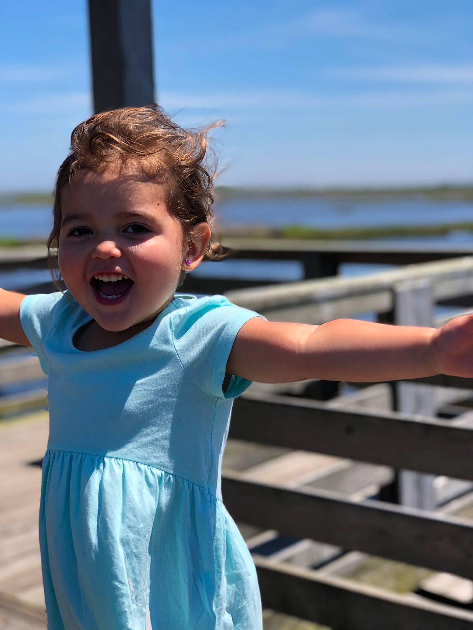 Maggie joined the competition — help win amazing prizes! beach, blue, child, coast, fun, gesture, happy, joy, leisure, ocean, person, photography, sea, smile, summer, t_shirt, toddler, tourism, vacation, water