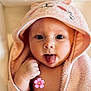 Victoire participe au concours pour gagner de l'argent avec cette photo : baby, child, towel, hood, pink, face, tongue, cute, playful, bathroom, skin, infant, person, expression, indoors, soft, wrapped, small, young, adorable