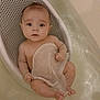 Dakota is registered to the contest to win money with this photo: baby, infant, bathtub, bath, towel, baby_bath_seat, water, bath_support, looking_at_camera, wide_eyes, bare_chest, small_hands, small_feet, toes, bathroom, plastic_seat, skin, cute, surprised_expression, white