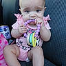 Dakota is registered to the contest to win money with this photo: baby, backseat, blanket, car_seat, chewing, close_up, cute, formula_can, hands, infant, infant_accessory, legs, pink_onesie, portrait, sitting, teether, teething, toy, wide_eyes, young_child