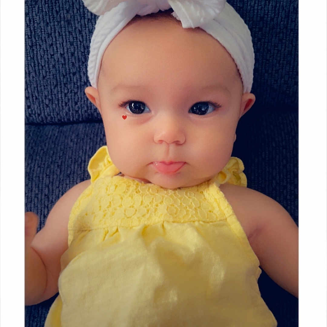 Lennox is registered to the contest to win money with this photo: accessories, baby, bodypart, bonnet, cap, clothing, doll, dress, face, finger, formalwear, hand, hat, head, headband, newborn, person, photography, portrait, toy