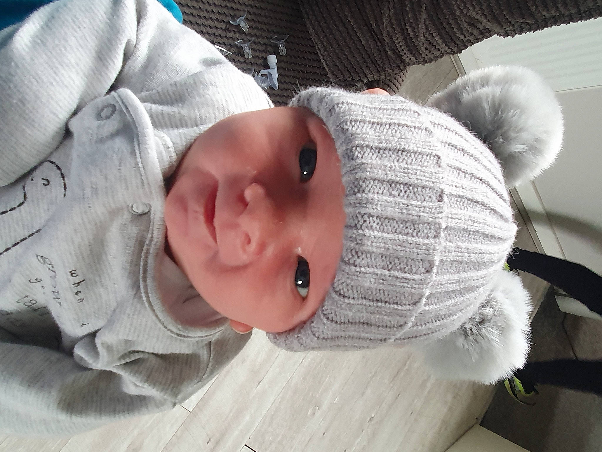 Riley is registered to the contest to win money with this photo: baby, baby_products, baby_toddler_clothing, cap, cheek, child, comfort, eyelash, face, fashion_accessory, hat, headgear, headwear, knit_cap, lip, nose, outerwear, person, skin, sleeve