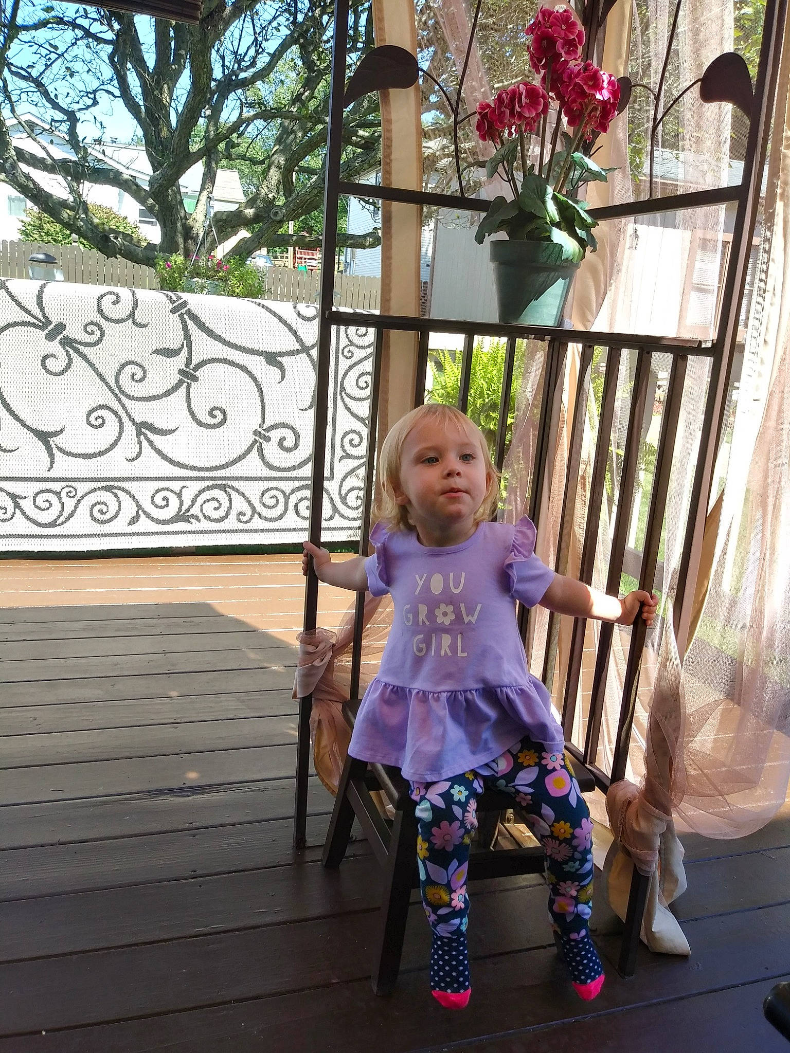 Serenity is registered to the contest to win money with this photo: baby, baby_toddler_clothing, chair, child, dress, event, fun, garden, grass, happy, leisure, magenta, outdoor_furniture, person, pink, plant, product, sitting, toddler, tree