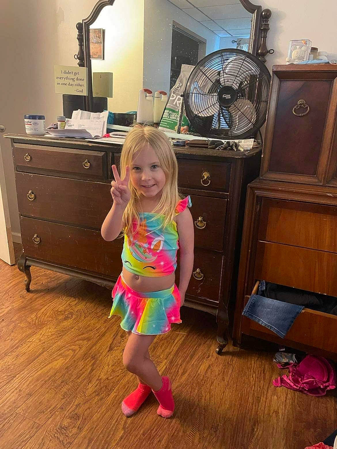 Serenity is registered to the contest to win money with this photo: beauty, cabinetry, chest, chest_of_drawers, cupboard, drawer, dresser, floor, flooring, furniture, hardwood, joy, kitchen, living_room, person, product, purple, smile, standing, toddler