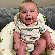 Mason joined the competition — help win amazing prizes! baby, smiling, infant, child, dinosaur, baby_seat, cute, happy, indoor, onesie, chubby, sitting, face, skin, human, portrait, couch, window, room, toy